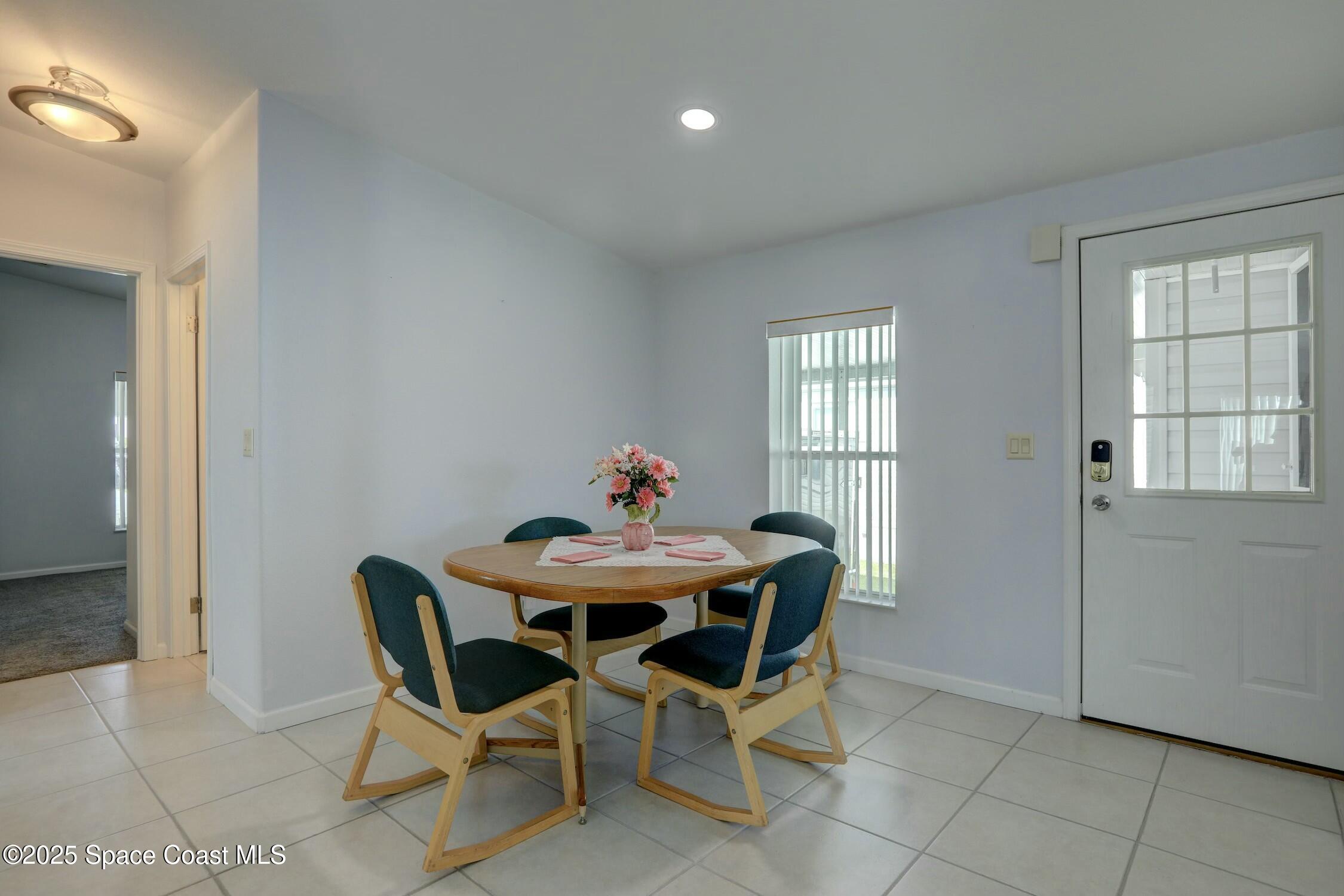 1124 Barefoot Circle Barefoot Bay, FL 32976 - Photo 45 of 79 a view of a dining room with furniture and window