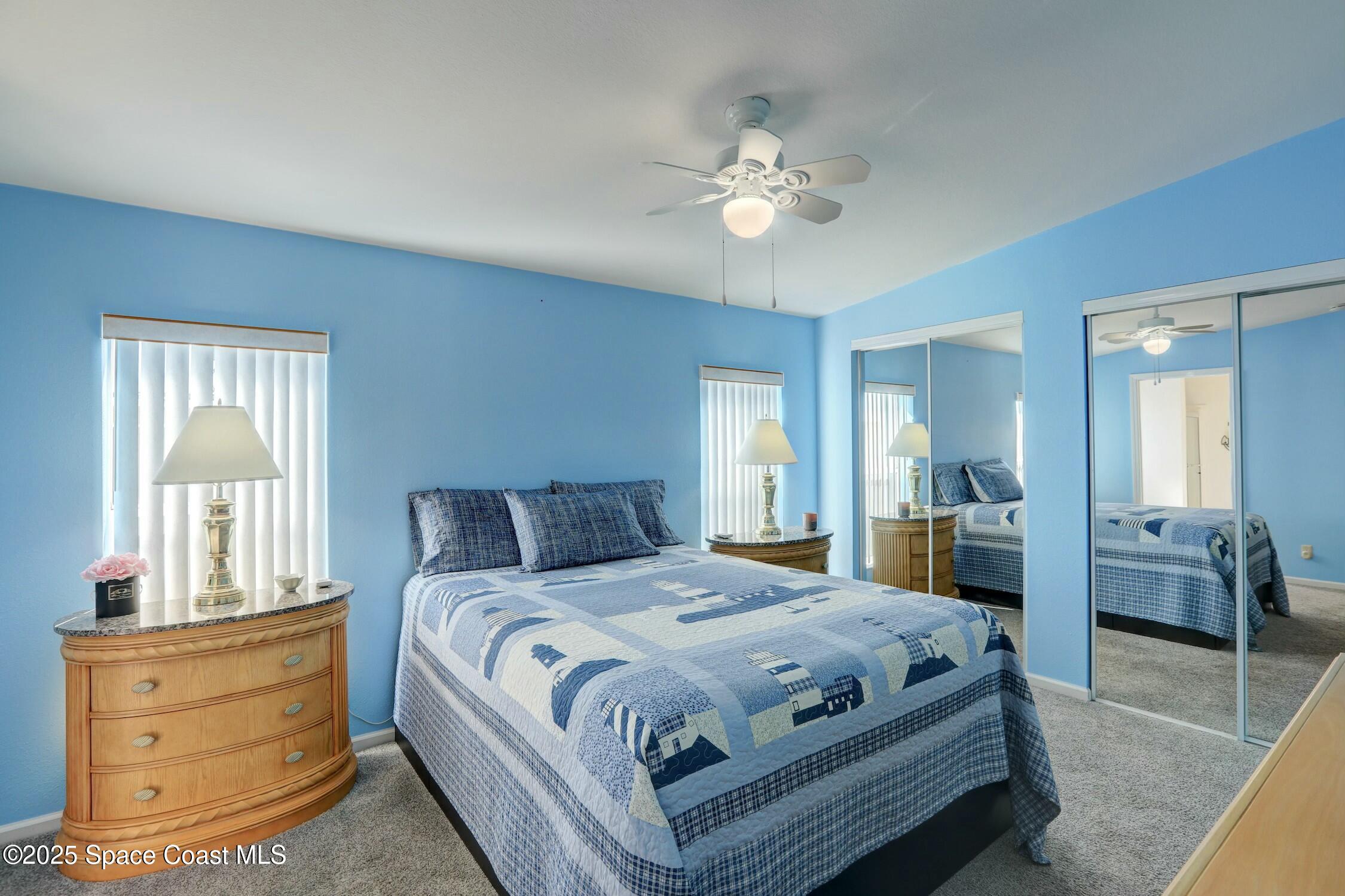 1124 Barefoot Circle Barefoot Bay, FL 32976 - Photo 55 of 79 a bedroom with a large bed and a chandelier