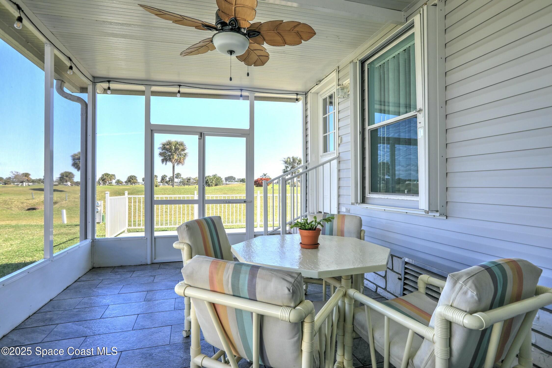 1124 Barefoot Circle Barefoot Bay, FL 32976 - Photo 63 of 79 a view of a dining room with furniture window and outside view