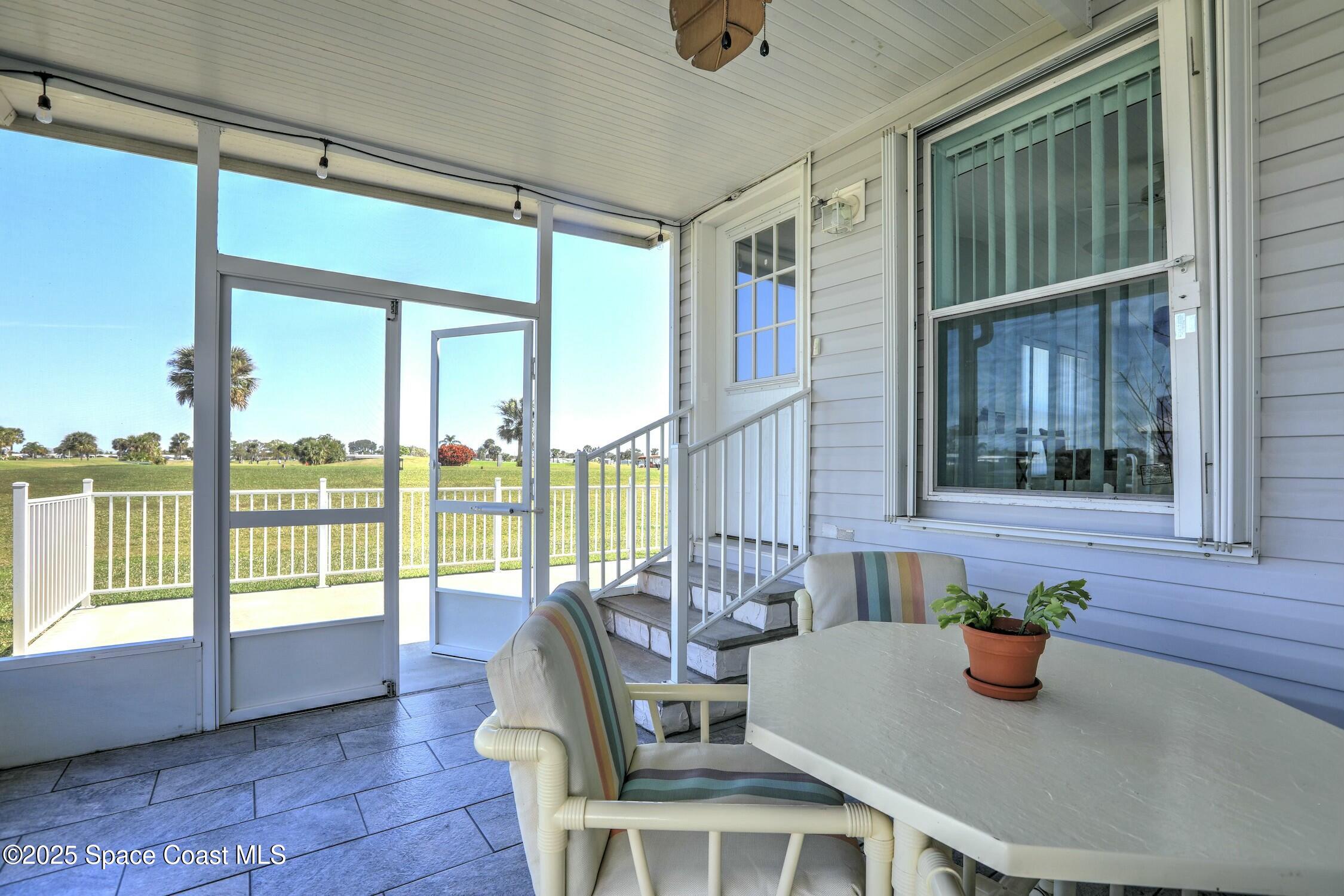 1124 Barefoot Circle Barefoot Bay, FL 32976 - Photo 65 of 79 a view of a dining room with furniture window and outside view