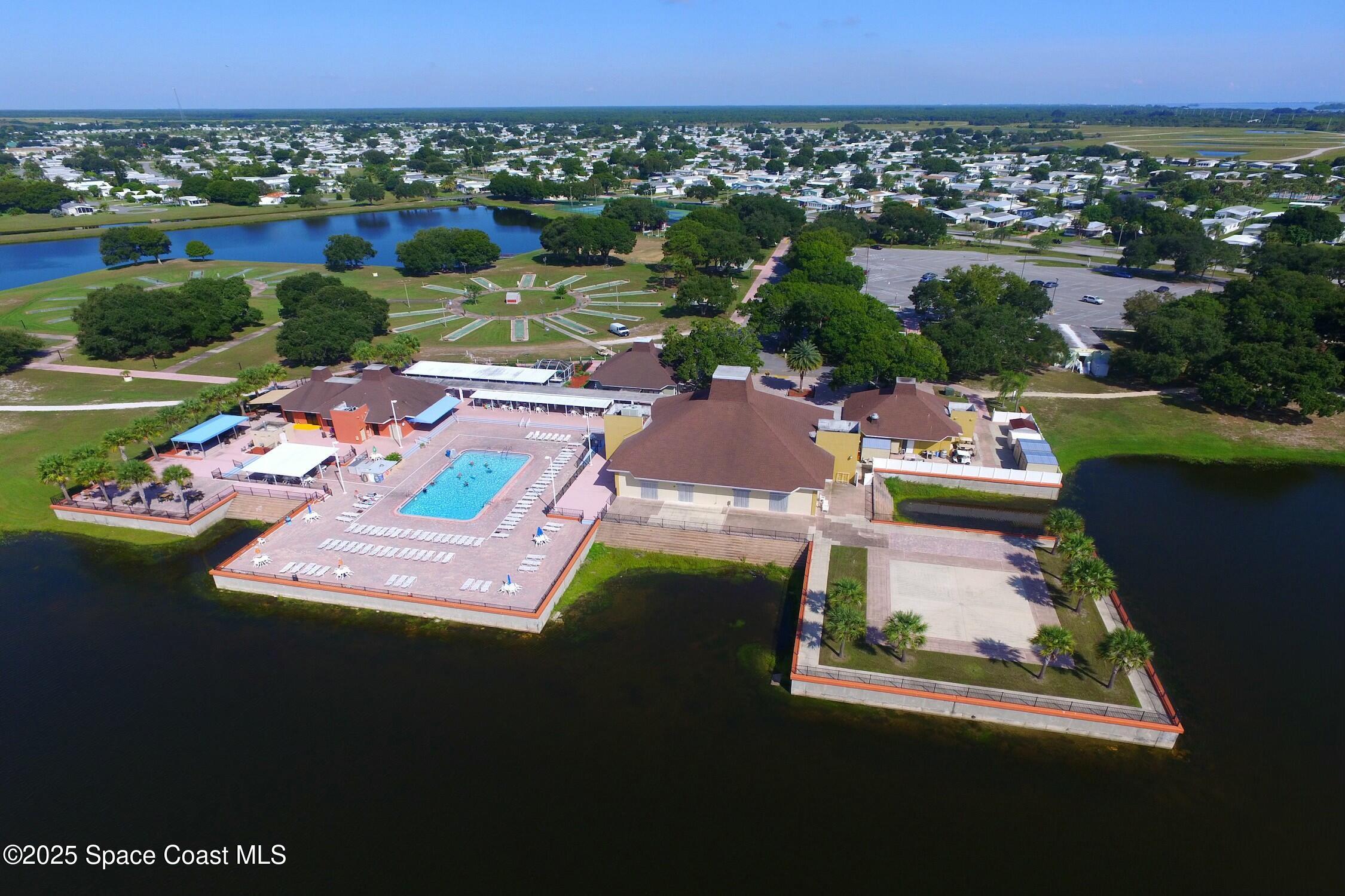 1124 Barefoot Circle Barefoot Bay, FL 32976 - Photo 72 of 79 an aerial view of residential houses with outdoor space and swimming pool
