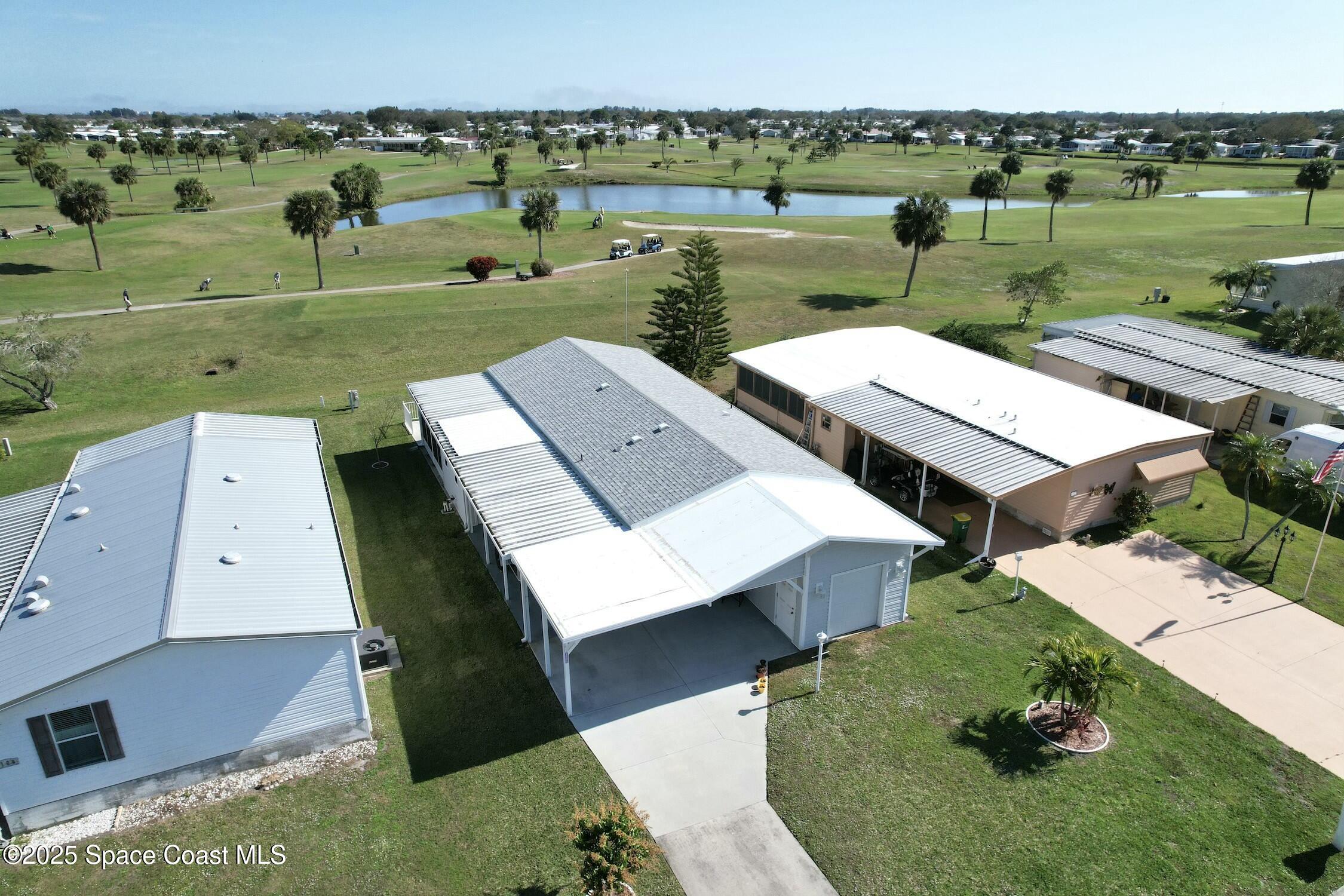 1124 Barefoot Circle Barefoot Bay, FL 32976 - Photo 10 of 79 an aerial view of a house with big yard