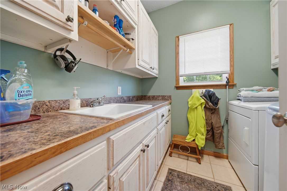 12159 Lawndell Road Southwest Beach City, OH 44608 - Photo 11 of 49 Laundry area featuring white cabinetry, a built-in sink, and laminate countertops