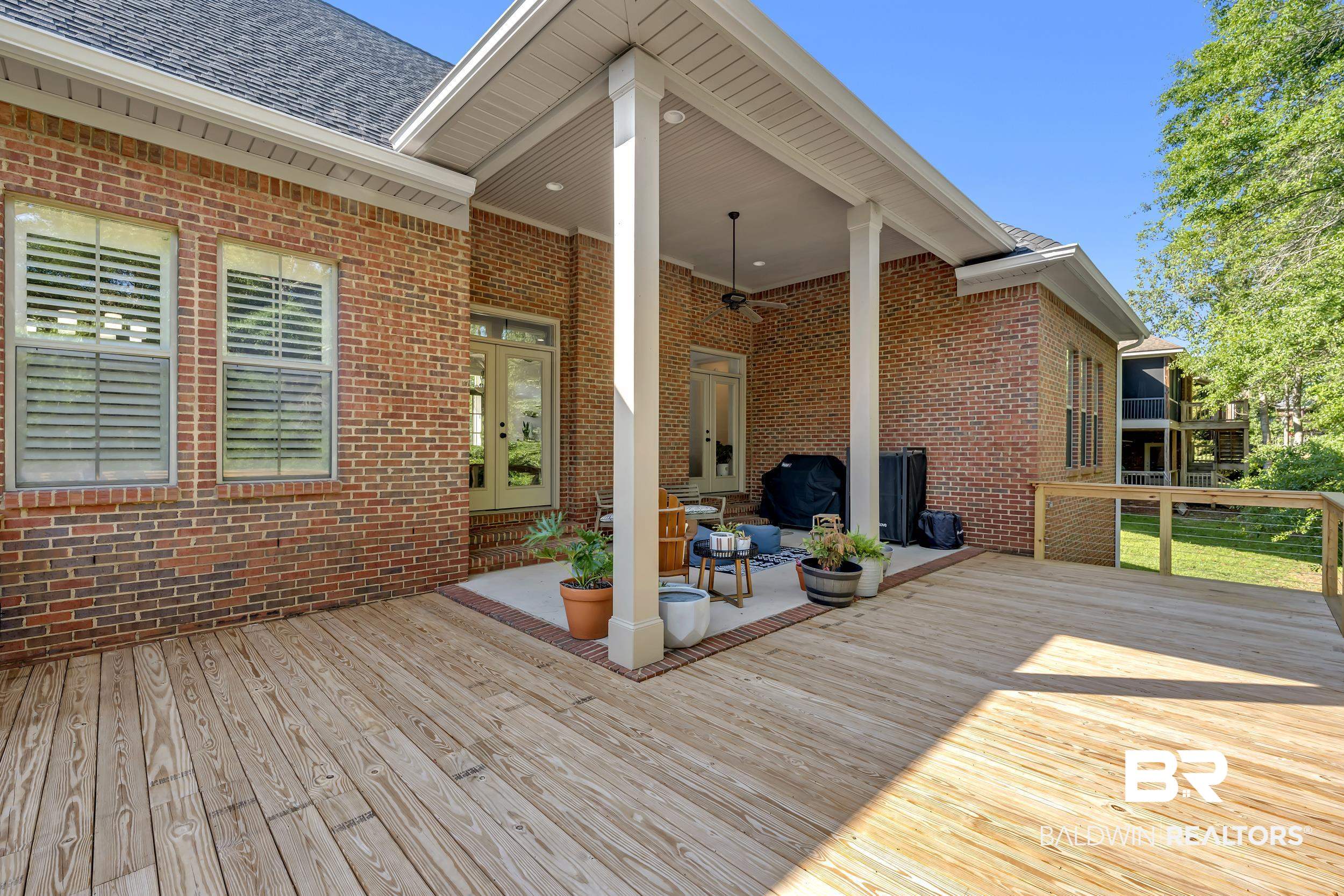 8137 Pine Run Daphne, AL 36527 - Photo 43 of 67 Expansive wood deck with a covered patio area and brick exterior