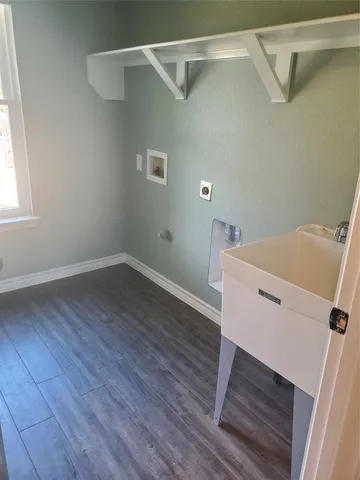 a view of a room with wooden floor and white walls