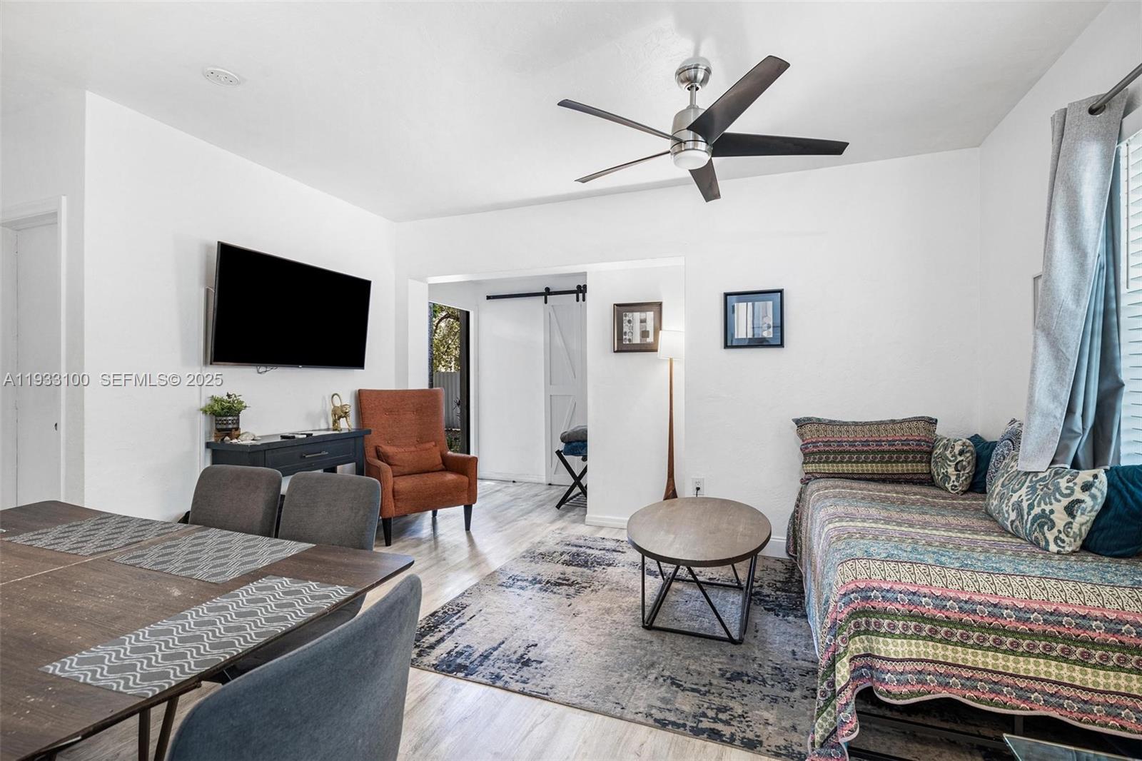 859 Northeast 90th Street Miami, FL 33138 - Photo 5 of 26 a living room with furniture and a flat screen tv