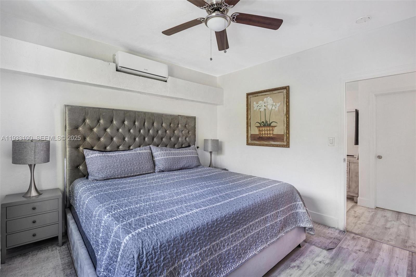859 Northeast 90th Street Miami, FL 33138 - Photo 10 of 26 a bedroom with a bed and a chandelier