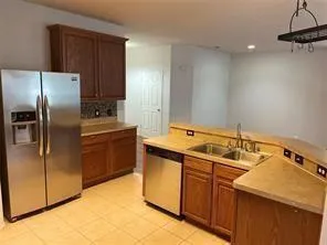 a kitchen with a stove sink and refrigerator