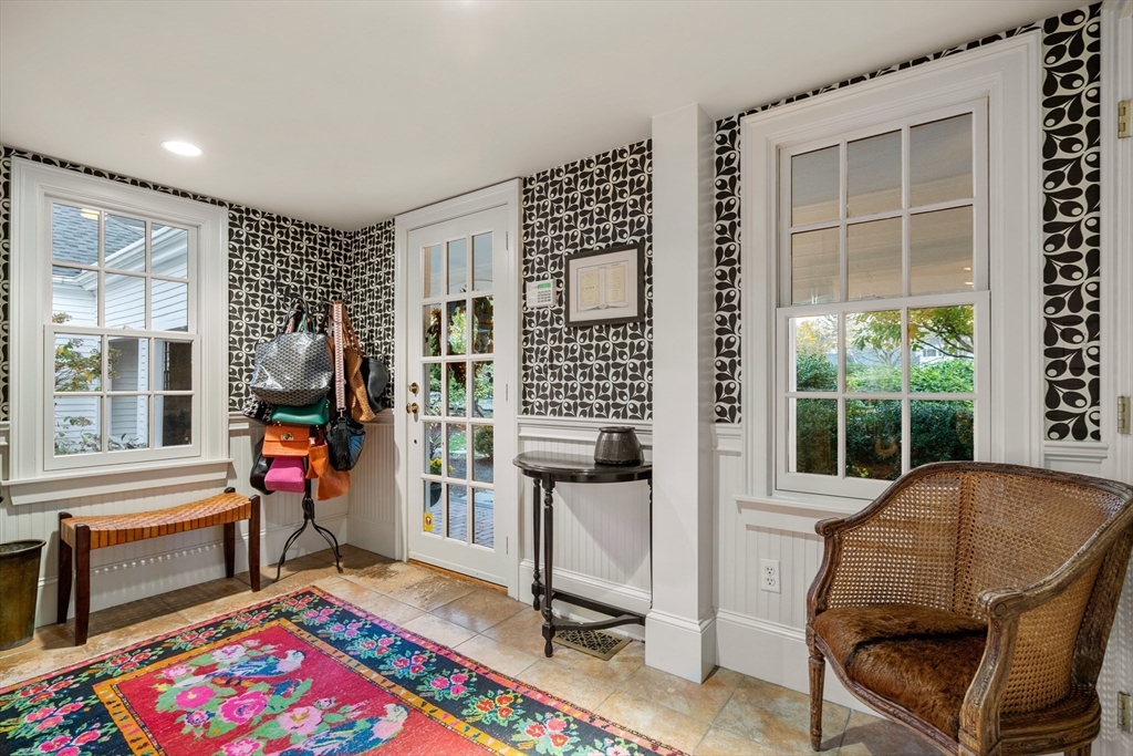 883 High Street Dedham, MA 02026 - Photo 13 of 42 a living room with furniture and a dining table next to a window