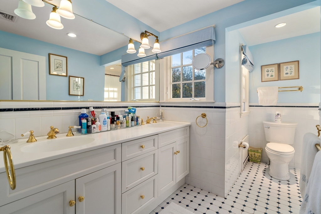883 High Street Dedham, MA 02026 - Photo 19 of 42 a bathroom with a sink a toilet and a mirror