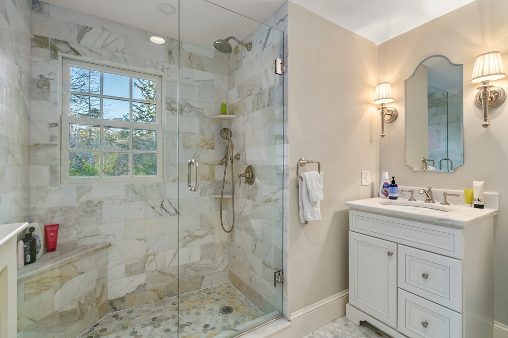 883 High Street Dedham, MA 02026 - Photo 22 of 42 a bathroom with a shower sink and mirror
