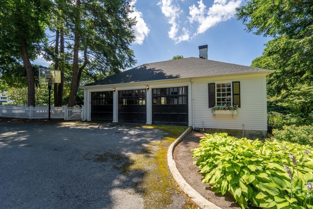 883 High Street Dedham, MA 02026 - Photo 24 of 42 a front view of a house with a garden