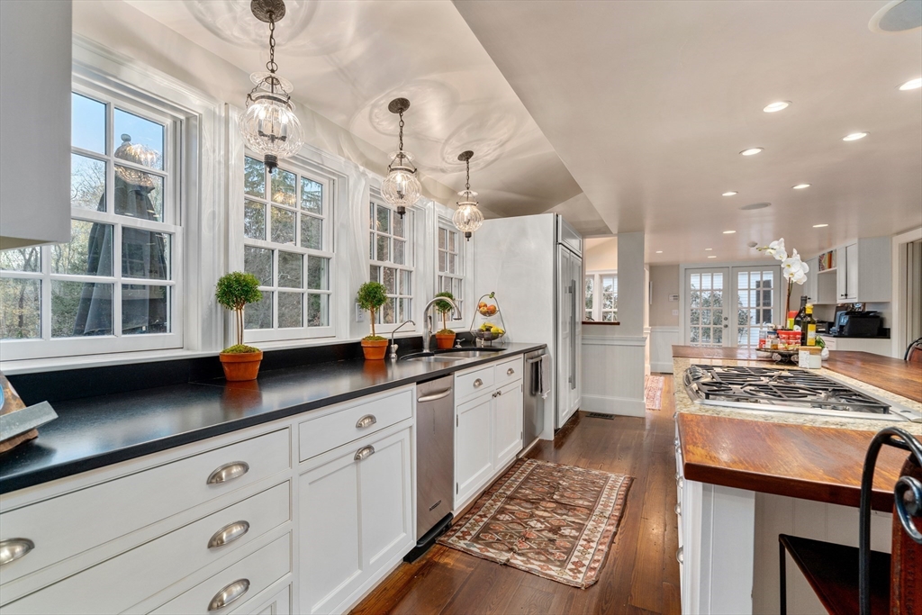 883 High Street Dedham, MA 02026 - Photo 9 of 42 a kitchen with stainless steel appliances granite countertop a stove and a sink