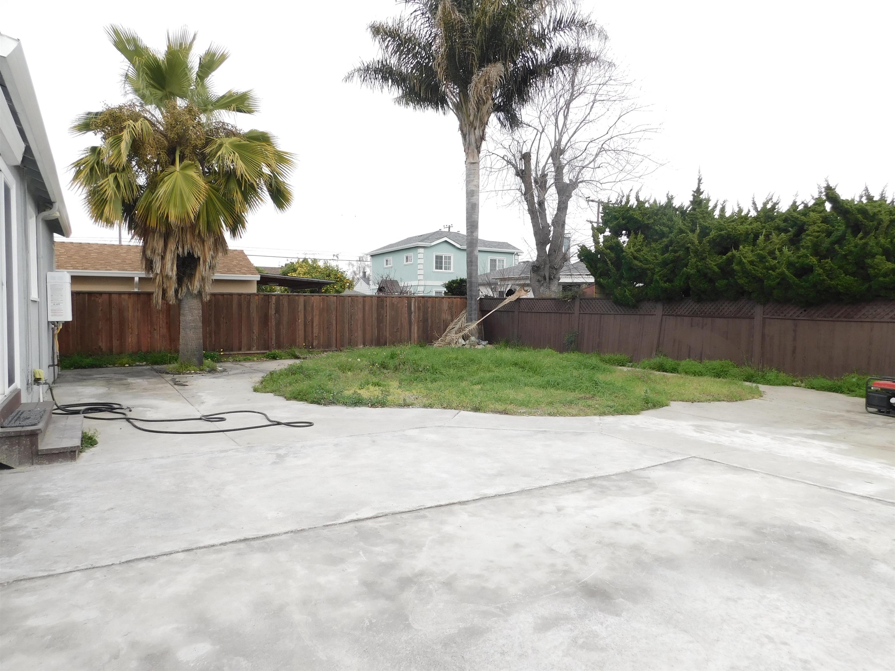 15018 Edgemoor Street San Leandro, CA 94579 - Photo 12 of 13 a backyard of a house with lots of green space and lake view