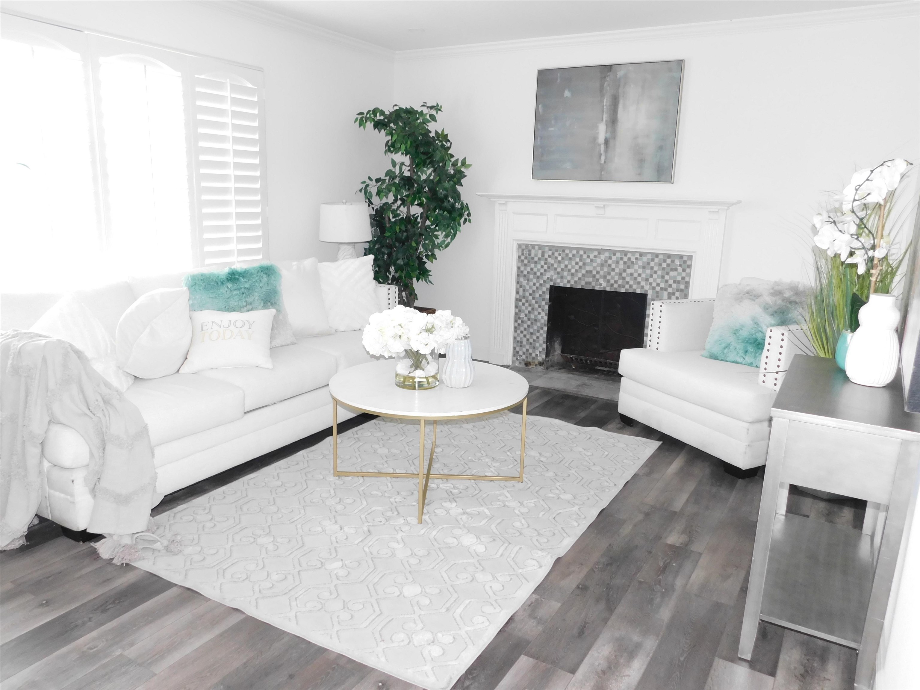 15018 Edgemoor Street San Leandro, CA 94579 - Photo 2 of 13 a living room with furniture a fireplace a potted plant and a fireplace