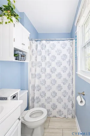 a bathroom with a toilet a sink and a mirror