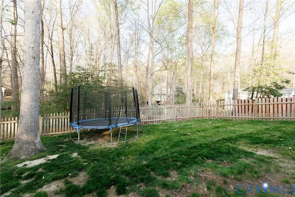 a view of a bench in backyard of house