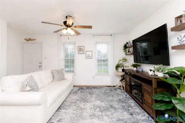 a living room with furniture and a flat screen tv