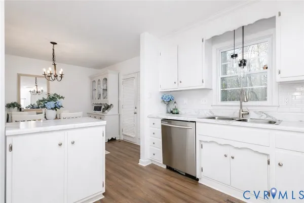 a kitchen with kitchen island white cabinets and white appliances