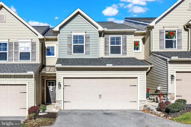 a front view of a house with a garage