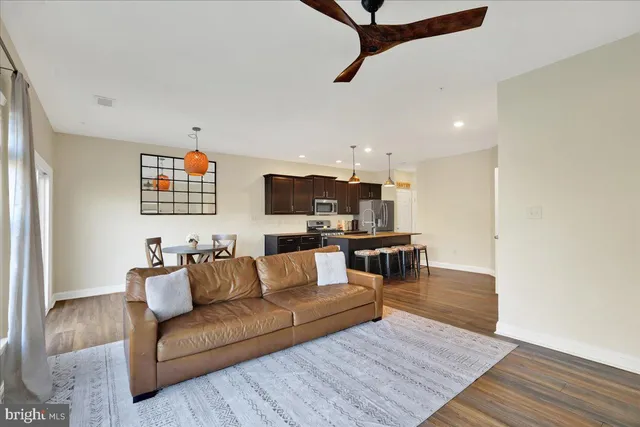 a living room with furniture and kitchen view
