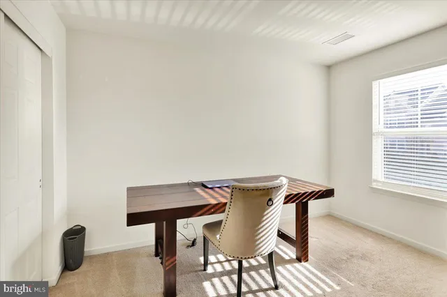 a view of a room that has a table and chairs in it