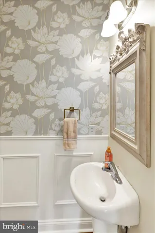 a bathroom with a sink a mirror and a shower