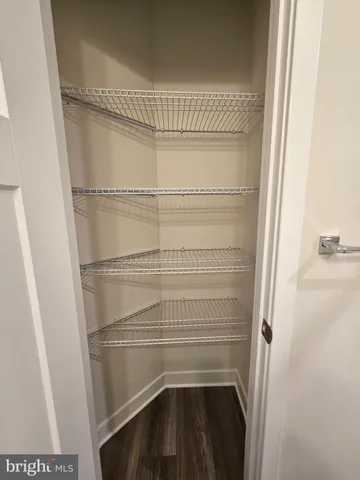 a view of an empty room and closet area