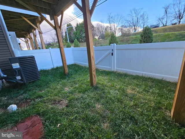 a large kitchen with stainless steel appliances a large counter top a sink a refrigerator and a stove