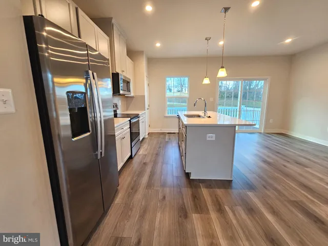 a view of kitchen with cabinets and wooden floor