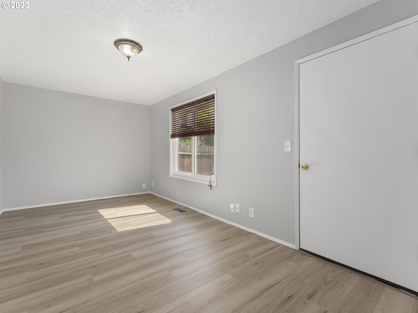 964 Southwest 179th Avenue Beaverton, OR 97003 - Photo 15 of 27 an empty room with wooden floor and windows