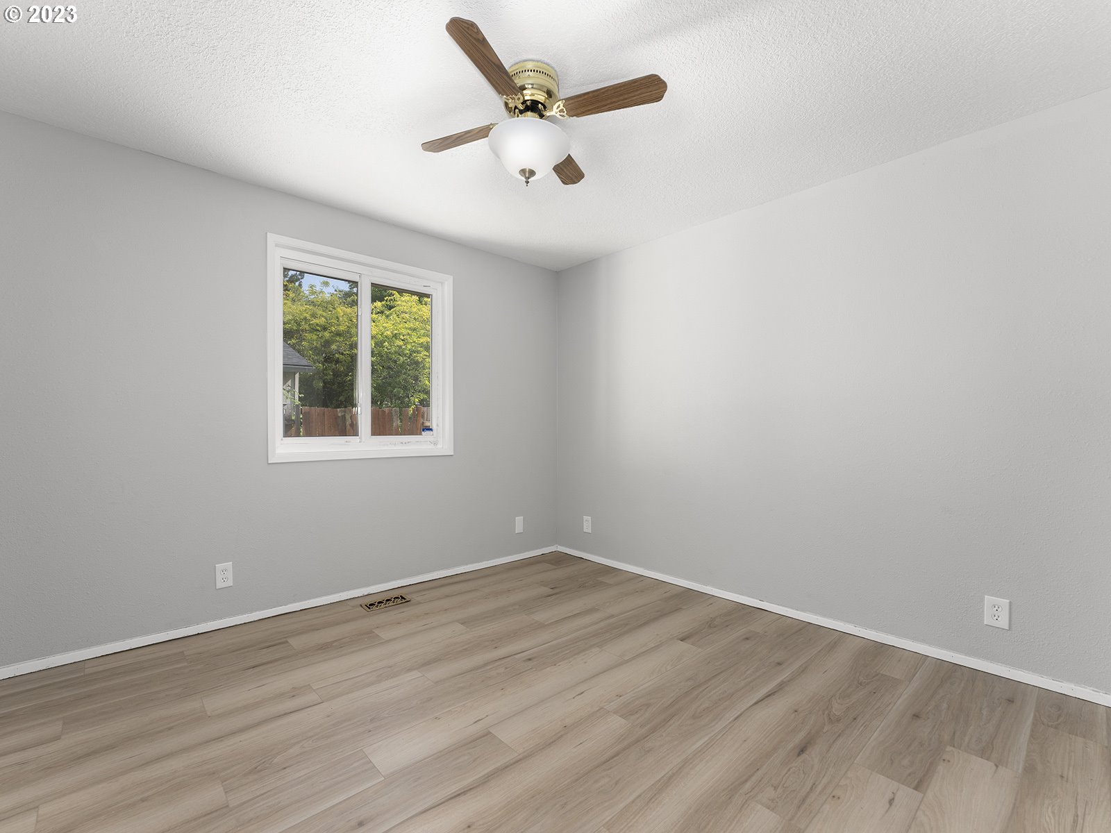 964 Southwest 179th Avenue Beaverton, OR 97003 - Photo 17 of 27 an empty room with wooden floor and ceiling fan