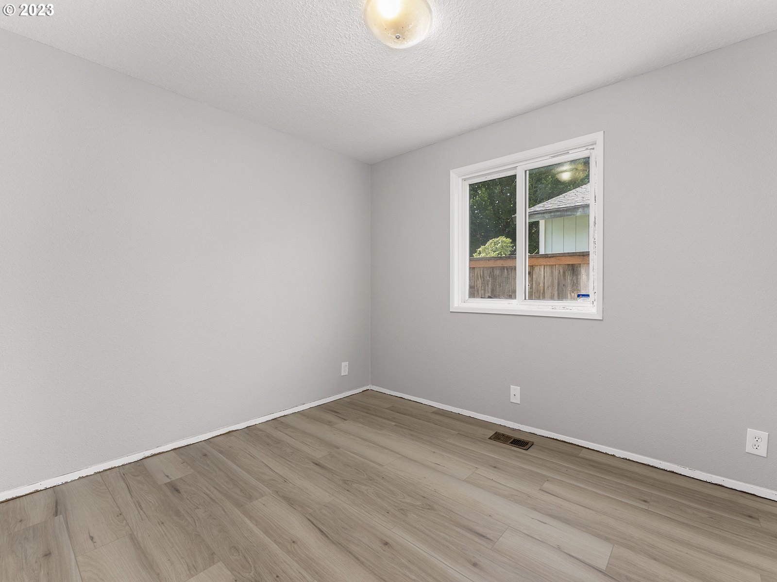 964 Southwest 179th Avenue Beaverton, OR 97003 - Photo 21 of 27 a view of an empty room with wooden floor and a window
