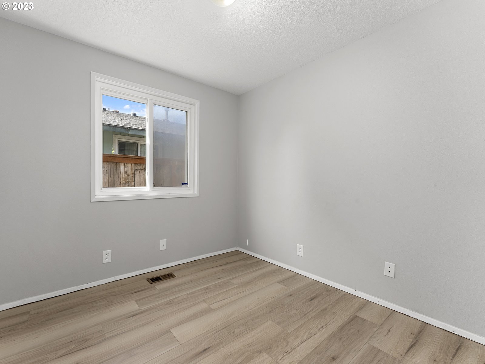 964 Southwest 179th Avenue Beaverton, OR 97003 - Photo 22 of 27 a view of an empty room with wooden floor and a window