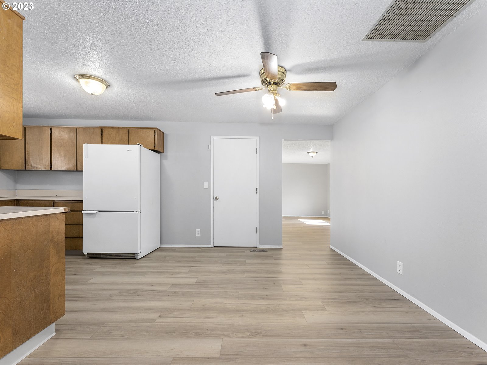 964 Southwest 179th Avenue Beaverton, OR 97003 - Photo 9 of 27 a view of an empty room with wooden floor and a ceiling fan