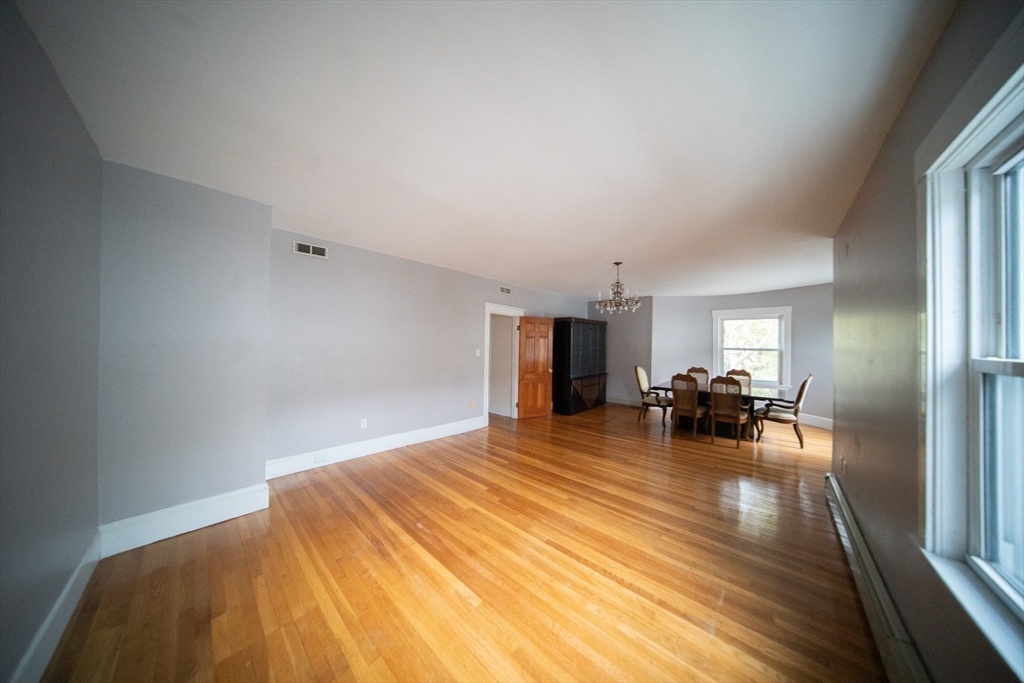 208 Rawson Road, Unit 3 Brookline, MA 02445 - Photo 11 of 33 a bed room with a bed and a chair