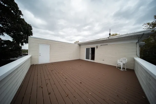 a view of a terrace with wooden floor and fence