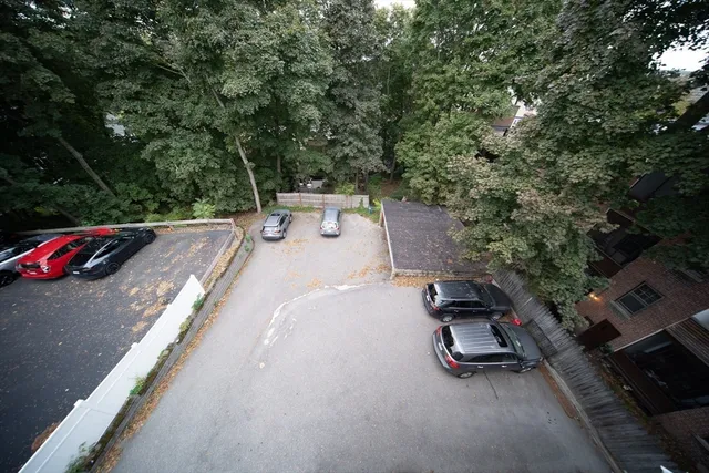 an aerial view of a tennis ground with large trees