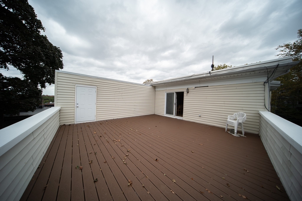 208 Rawson Road, Unit 3 Brookline, MA 02445 - Photo 25 of 33 a view of a terrace with wooden floor and fence