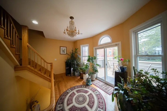 a living room with furniture and a floor to ceiling window