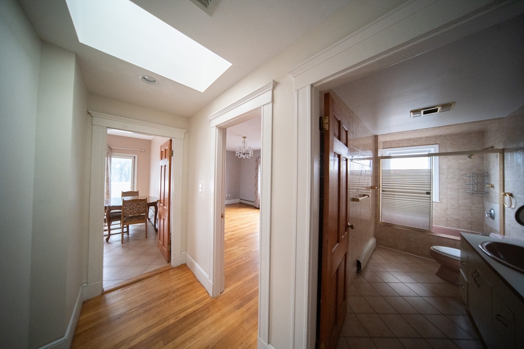 208 Rawson Road, Unit 2 Brookline, MA 02445 - Photo 3 of 33 a view of a hallway view with wooden floor and living room