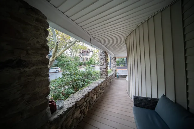 a view of a balcony with wooden floor and outdoor space