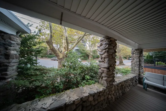 a couple of flower plants in front of a house
