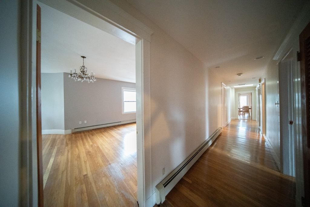208 Rawson Road, Unit 2 Brookline, MA 02445 - Photo 8 of 33 a view of a hallway with wooden floor