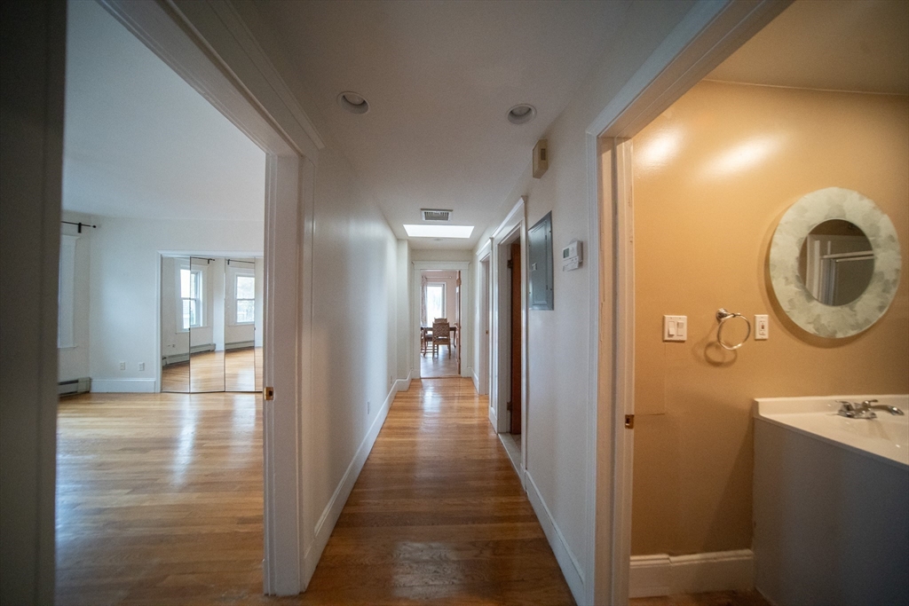 208 Rawson Road, Unit 3 Brookline, MA 02445 - Photo 9 of 33 a view of a hallway with wooden floor