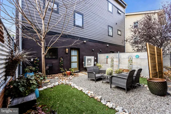 a view of a backyard with sitting area