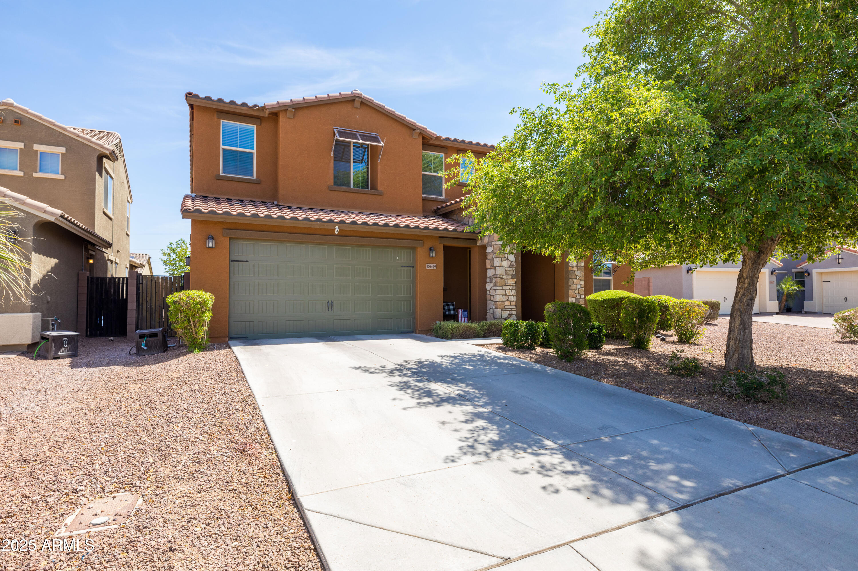 18649 West Williams Street Goodyear, AZ 85338 - Photo 1 of 42 a front view of a house with a yard and a garage