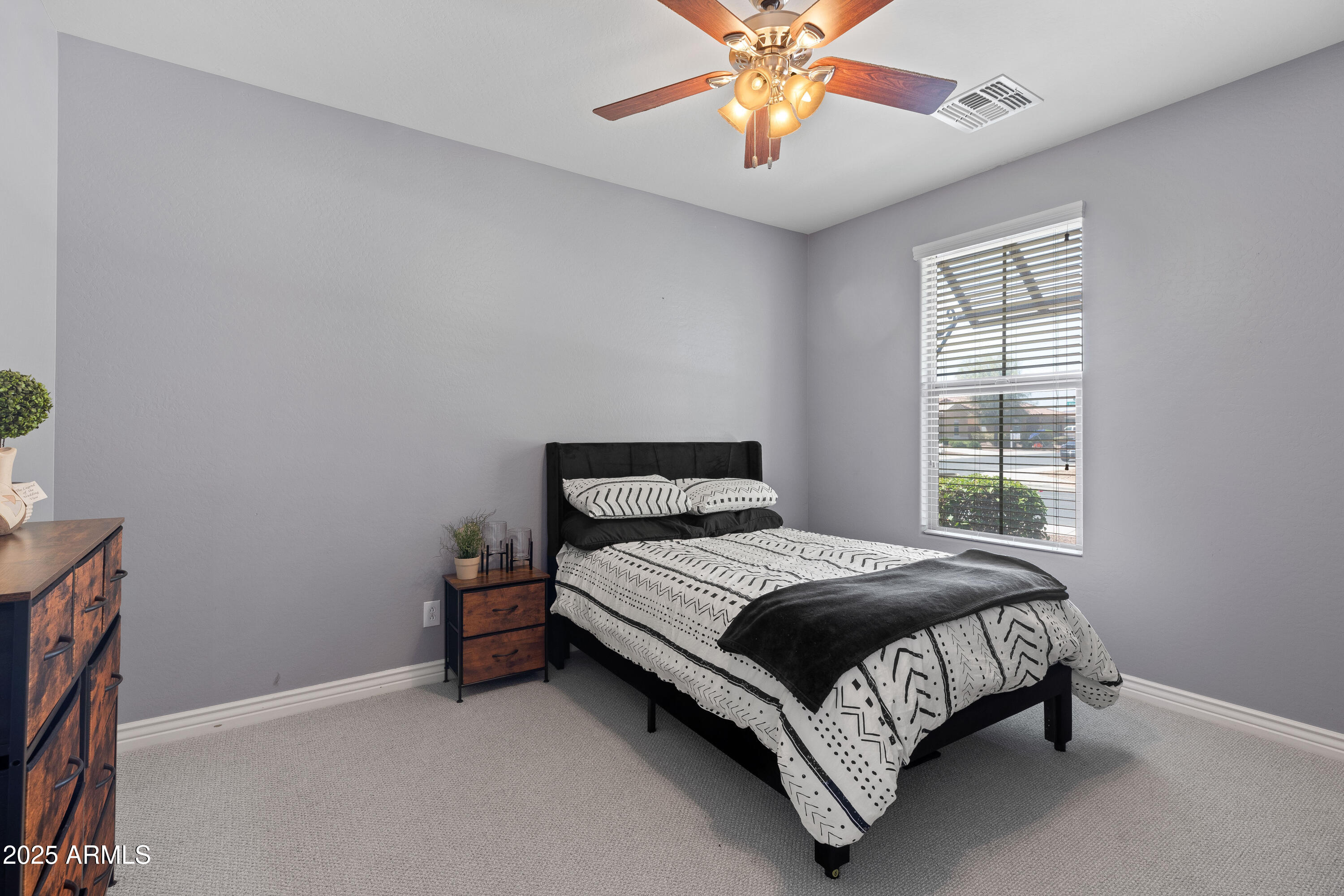18649 West Williams Street Goodyear, AZ 85338 - Photo 15 of 42 a bed sitting in a bedroom next to a window
