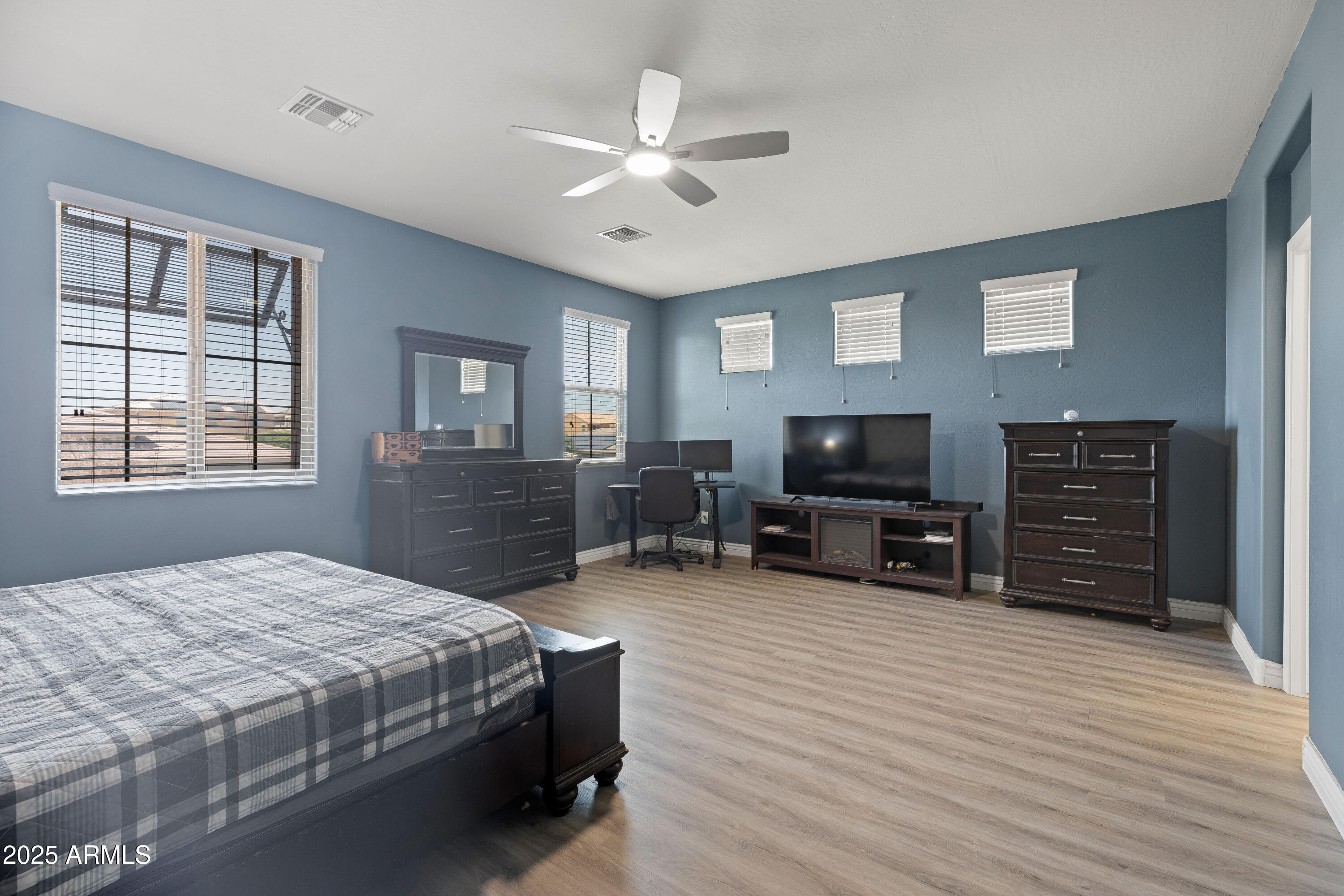 18649 West Williams Street Goodyear, AZ 85338 - Photo 19 of 42 a bedroom with furniture and a flat screen tv