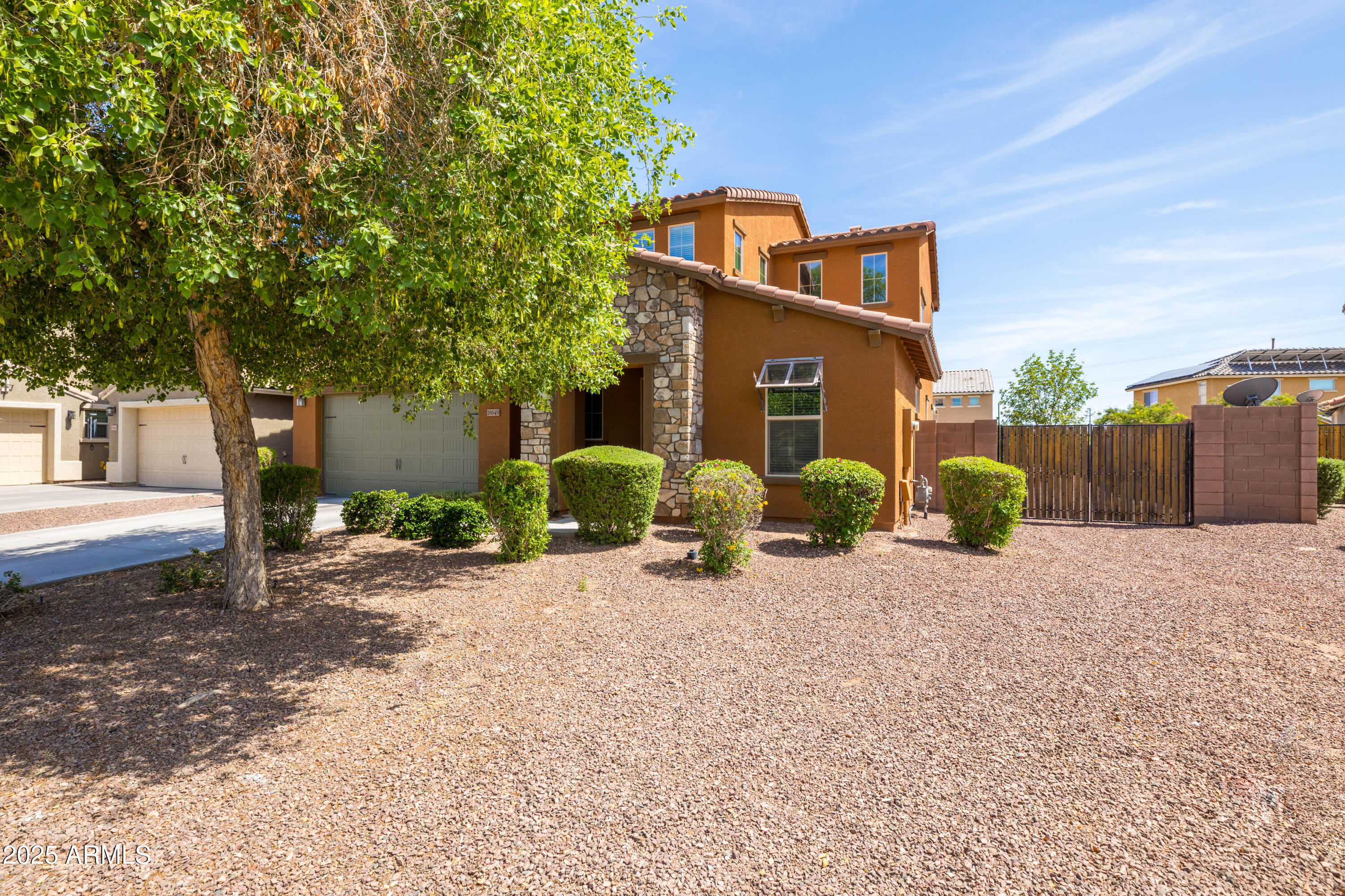 18649 West Williams Street Goodyear, AZ 85338 - Photo 2 of 42 a front view of a house with a yard and garage